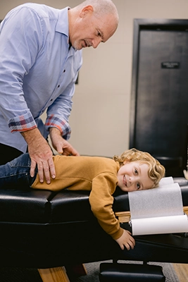 Chiropractor Harrison AR Paul Williams Adjusting Child